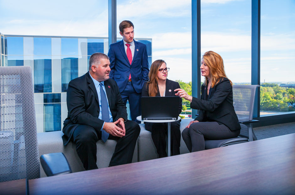 A group of professionals gather at the headquarters of U.S. Mortality Markets to discuss client needs