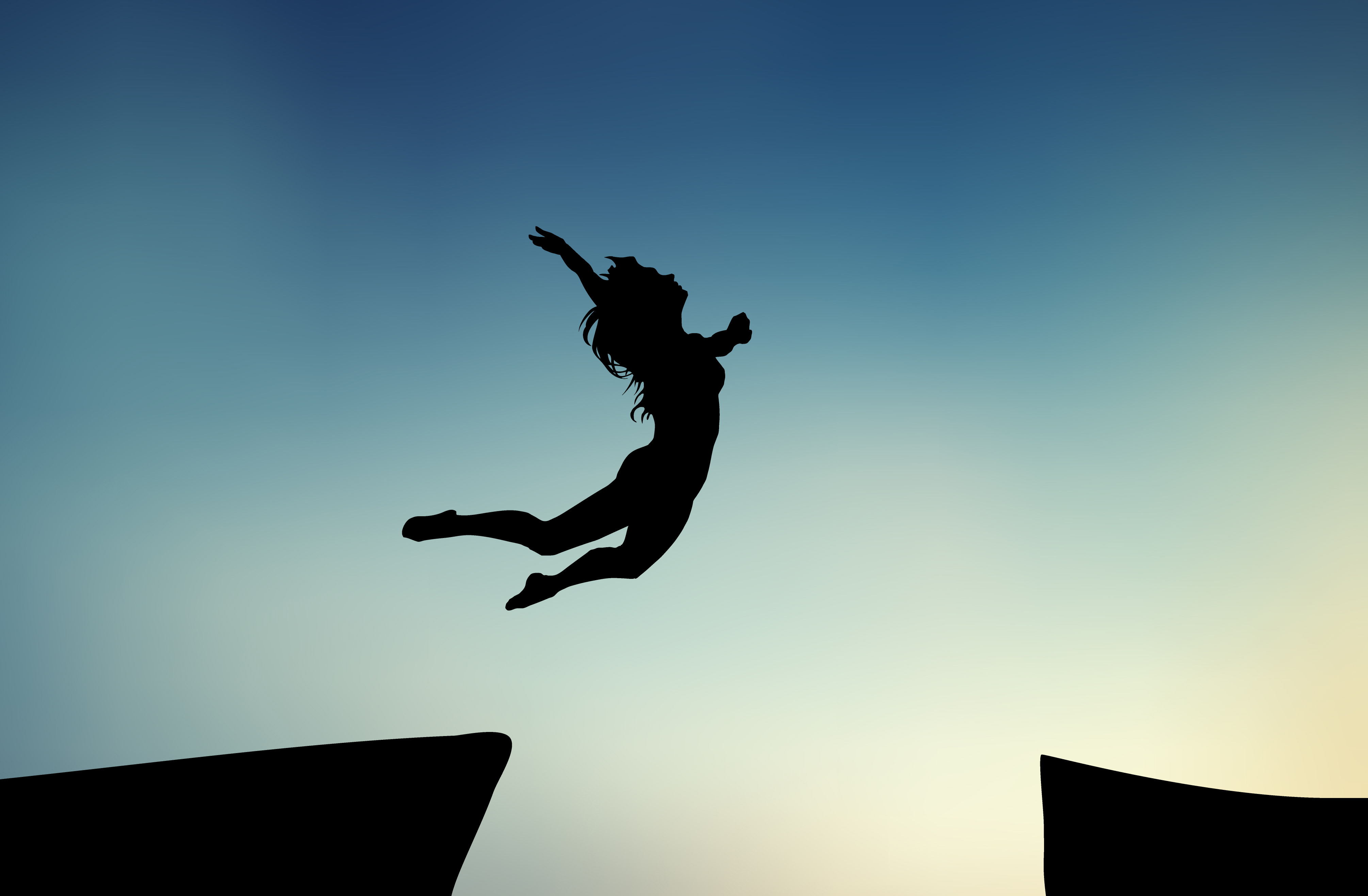 Figure jumping across a cliff