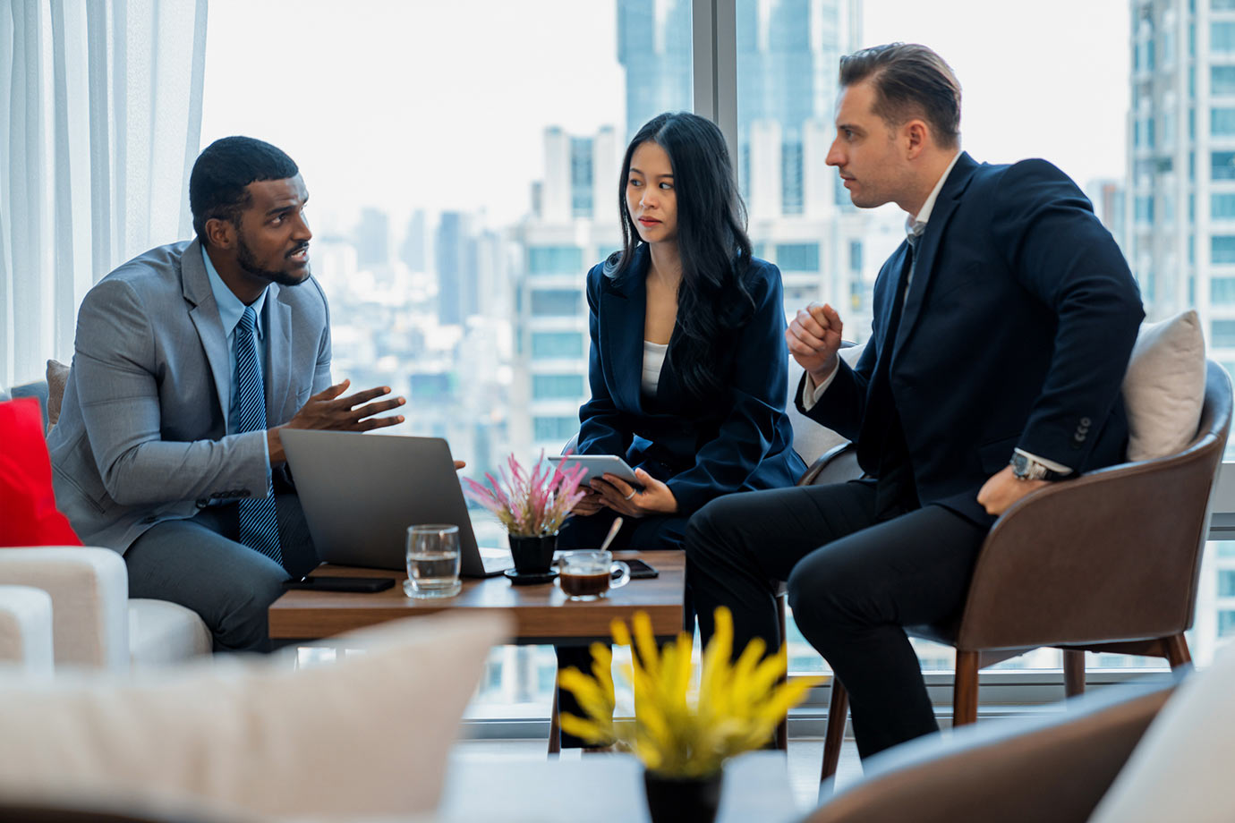 Two men and a woman meting in a casual office environment