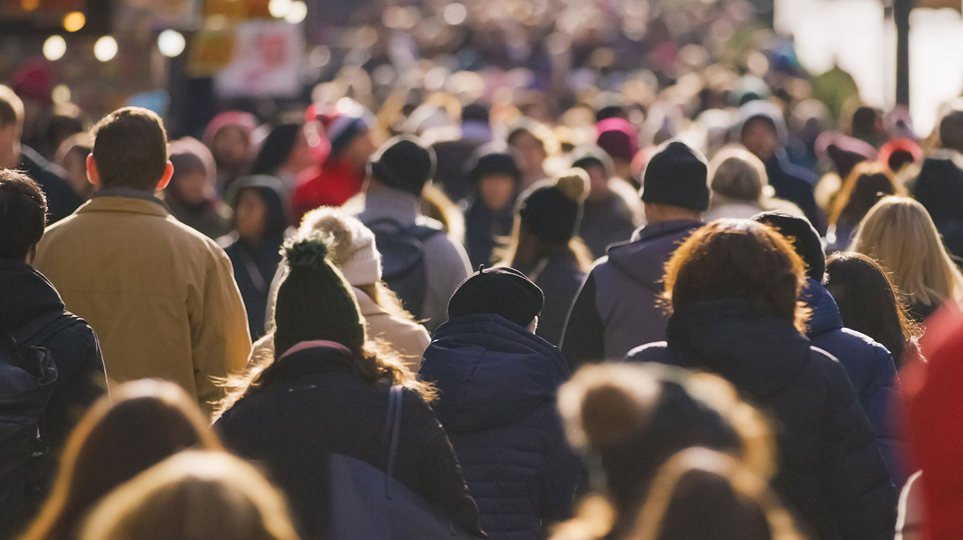 Crowded city street full of people with coats on