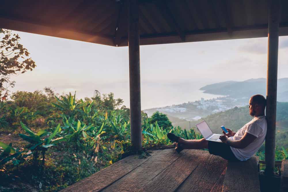 Individual working from tropical paradise