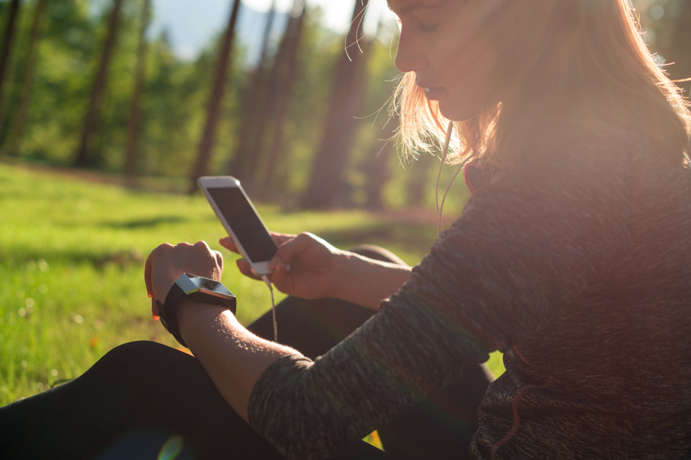 Wearable Technology in Life Insurance: Woman checks devices