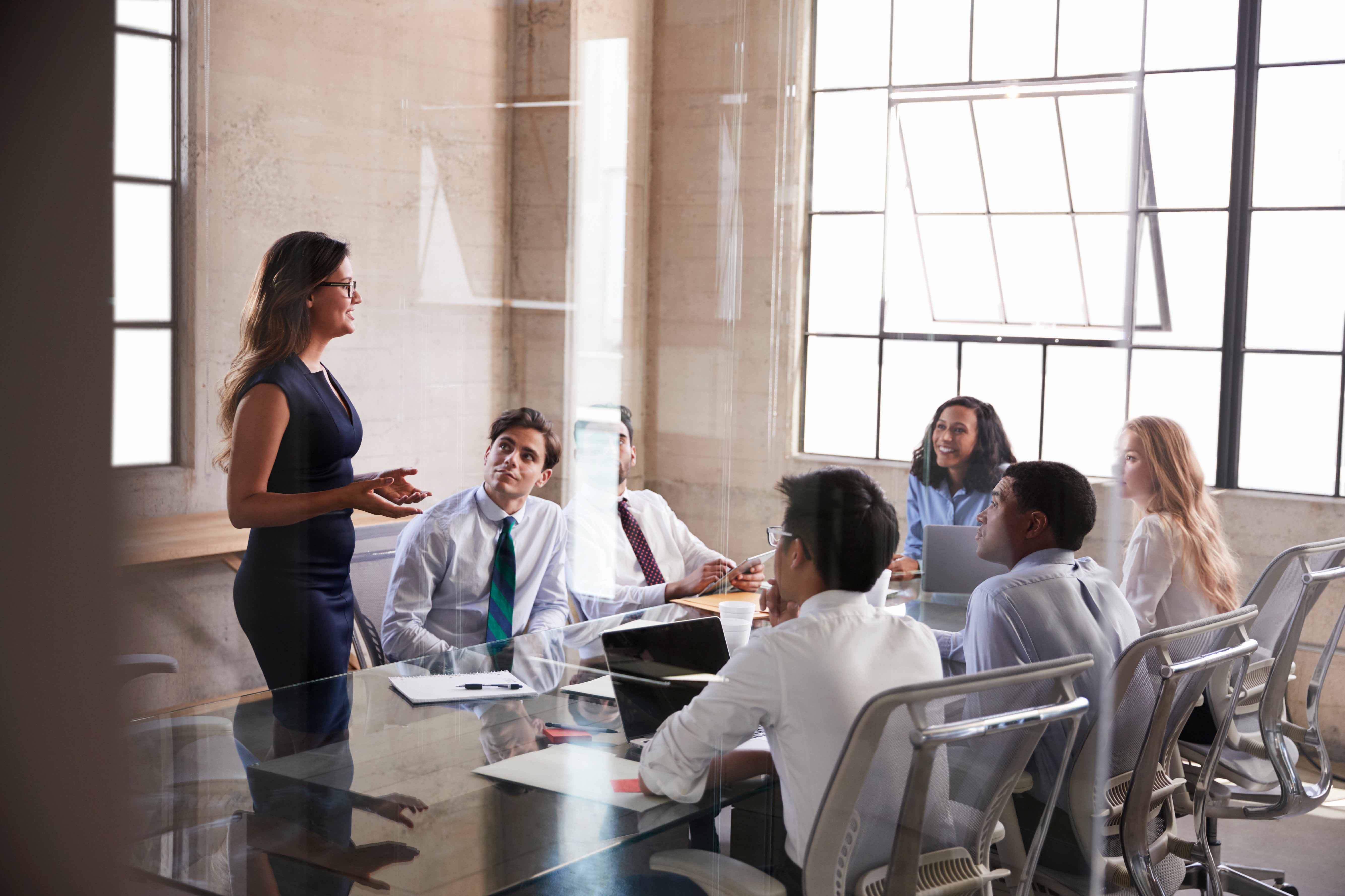 Women Leadership - a professional woman speaks to a group