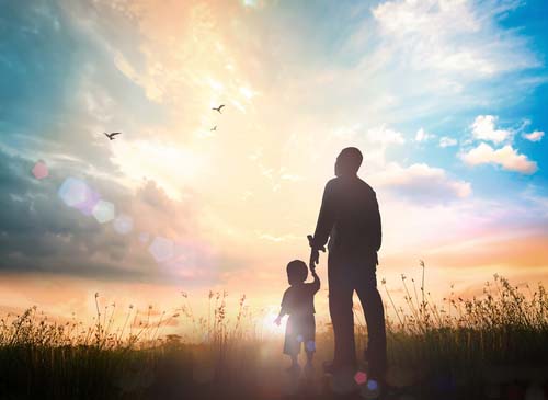 Family in silhouette gazing into the distance