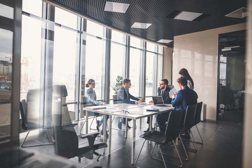 Glasswalled conference room and business meeting