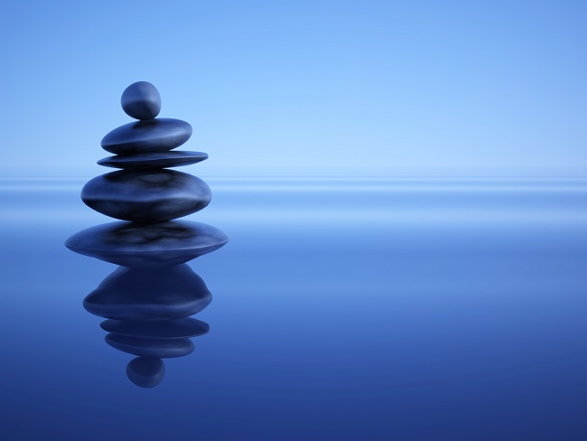 Image of longevity via cairn of stones against water