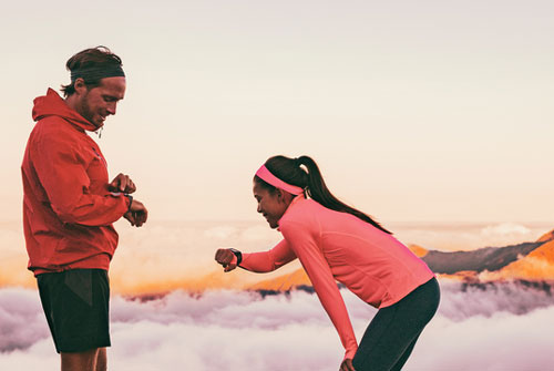 Runners checking wearable devices