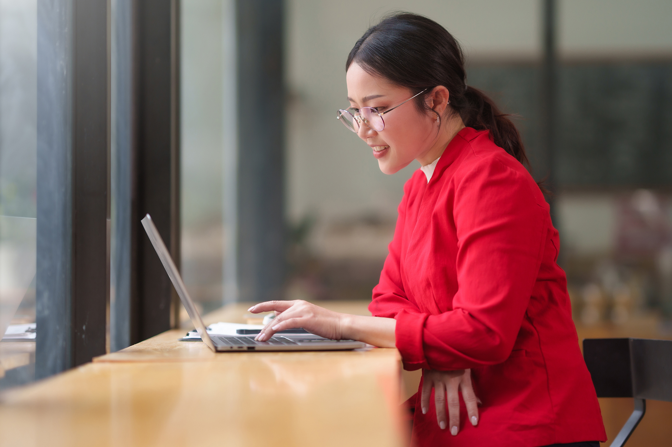 Woman in red shirt using computer artificial intelligence