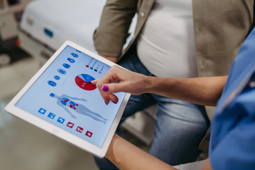 Doctor and patient looking at obesity scan results