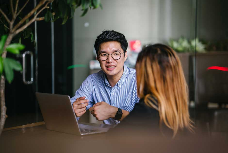 A pair of colleagues discuss health topics in an office