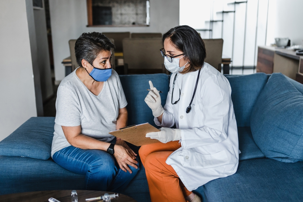 A hispanic nurse conducts a home healthcare visit with a patient