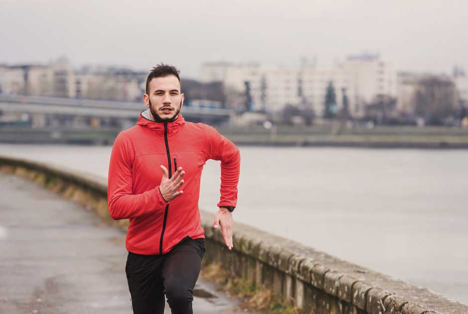 A runner exercises along a waterfront