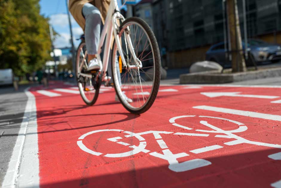 A biker pedals down a reserved lane on a city street.